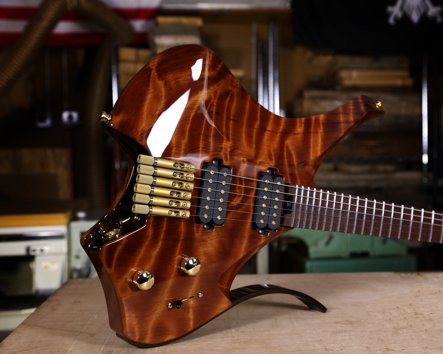 Body photo of a Virtus headless full carve guitar made of figured redwood. 